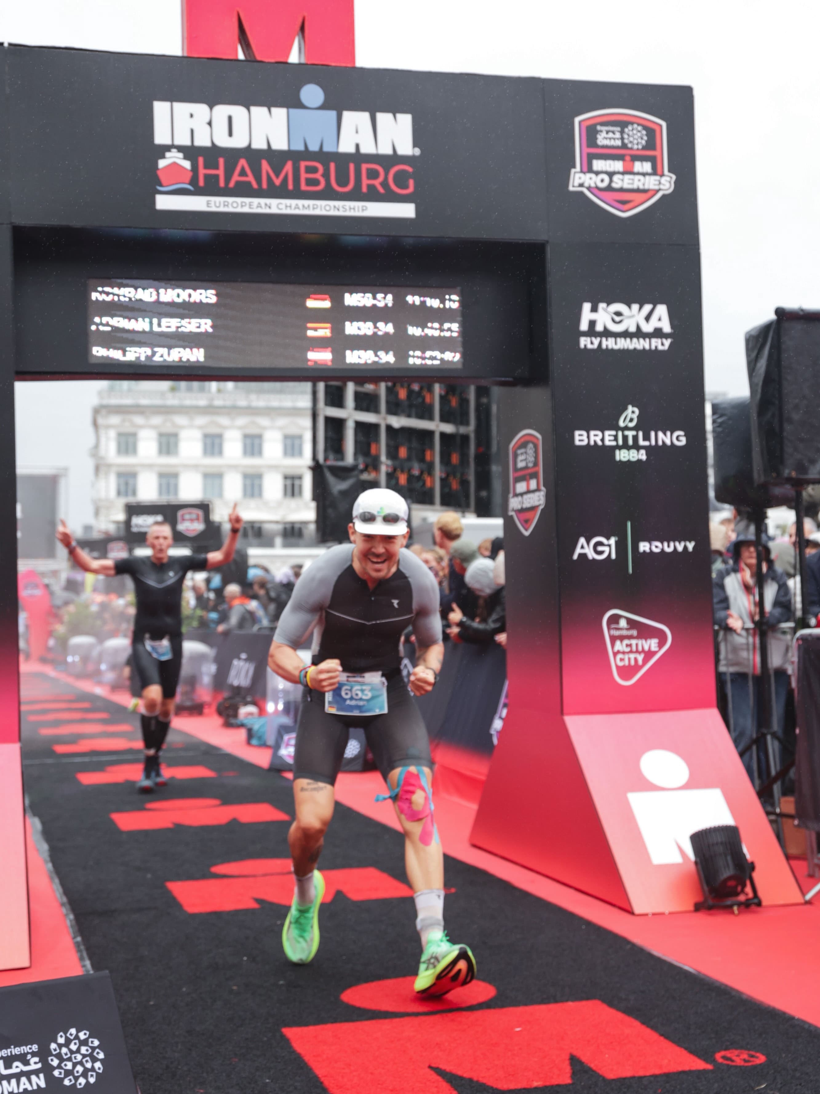 Adrian crossing the IRONMAN Hamburg finish arch.